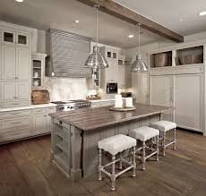 Conceal a refrigerator with light gray wood panels matching the surrounding shaker cabinets finished with polished nickel pulls. Reclaimed Wood Countertops Contemporary Kitchen The Owen Group