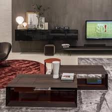 For instance, try placing a large, flat book on the coffee table and adding a smaller book or decor item like a candle on top of it. Stage Coffee Table By Molteni C