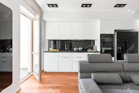 Before the upholstery of the kitchen sofa, make sure that all elements are assembled correctly and pasting the back and seat of the sofa with foam rubber. Modern Living Room With Sofa Balcony And White Open Kitchen Stock Photo Picture And Royalty Free Image Image 91344758