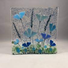 Copper pipe, ribbon and fused glass combine to create a simple, but beautiful fused glass wall hanging. Floral Glass Plaque Candle Display Blue Flowers Fused Glass Home Decor Birthday Present Mothers Day Gift Glass Flowers Glass Fusing Projects Fused Glass Dishes