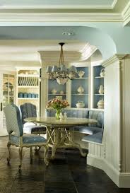 Whtie can back bamboo chairs at an oval saarinen table atop a tan bound sisal rug. Blue Dinong Nook French Country Dining Room French Country Dining Room Decor French Country Decorating Living Room