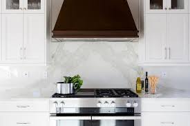 White backsplash with gray kitchen cabinets. Dark Brown Vent Hood With White Kitchen Cabinets Transitional Kitchen