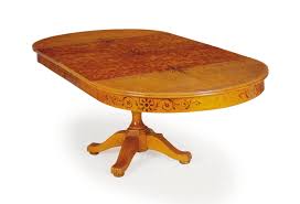 This oval cocktail table displays two gorgeous pieces of birdseye maple, awash in a sheer ecru finish, beaded in soft radiance, and rimmed with a metal. An Inlaid Birdseye Maple And Grain Painted Circular Dining Table