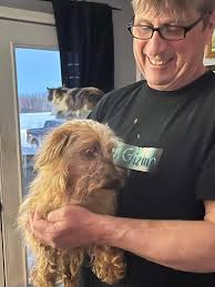 Volunteer helps clean dog play yard