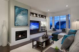 The wall mounted tv on a white backdrop blends in with the white walls, mixing in well with the overall monochrome theme of the room. Tv And Furniture Placement Ideas For Functional And Modern Living Room Designs