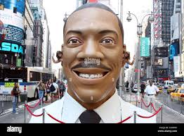A 15 foot tall replica of Eddie Murphy's head is placed in Times Square to  promote the release of his new film 'Meet Dave'. New Stock Photo