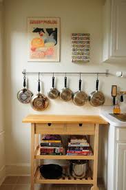 Pots and pans pose a particular challenge pots and pans suspended underneath a countertop don't have to look industrial or utilitarian. Julie 08 Rect640 Home Decor Hang Pots And Pans Home Kitchens