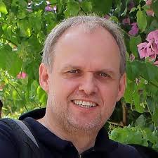 Is it possible to summon an ally in a hex containing a closed door, thereby  opening the new room?