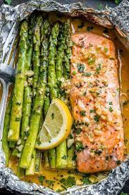 Baked Salmon In Foil With Asparagus And Garlic Lemon Butter Sauce Baked Salmon And Asparagus Delicious Salmon Recipes Baked Salmon Recipes