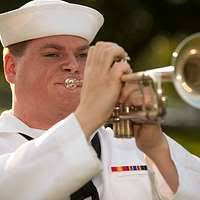 Petty Officer Third Class Jonathan Holladay performs