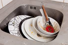 dirty dishes in kitchen sink stock