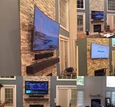Curved Tv Mounted On Stone Fireplace Power And Hdmi Installed And Sound Bar Mounted B Beach House Interior Tv Mount Over Fireplace Tv Mounted Above Fireplace
