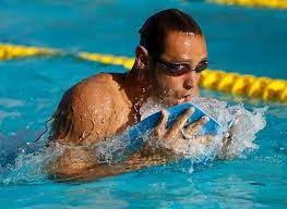 The Swimmer S Ultimate Guide To Swim Paddles Swimmer Swimming Workout Swimming Motivation