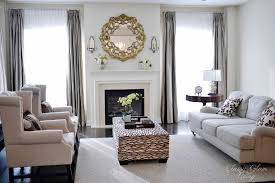 Arranging living room furniture diagonally gives a boxy room more dimension and creates a welcoming pathway into the seating group. Classy Glam Living