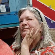 Hopi potter Bobby Silas holding the coal-fired, Sikyátki-inspired jar that  is the newest addition to ASM's collections. Depicted