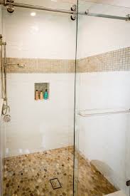 Tile trims and edging help give your tiling projects a finished and clean look. View Of The Shower For The Guest Bathroom Love The Glass Barn Door Along With The Pebble Shower Floo White Subway Tile Shower Shower Tile Pebble Shower Floor