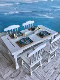 This Gorgeous Beach Themed Table And Chairs Has Been Set For A Nautical Dinner Party There Are Four Place Settings Beach Furniture Table And Chairs Furniture