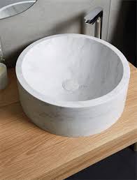 Oak cabinets resurfaced in creamy white (visible wood grain). Corian Solid Surface Sinks Basins Charging Surfaces