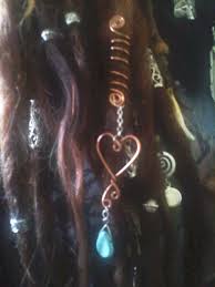 To fall or to allow something to fall: Golden Heart Turquoise Drop Dread Wrap