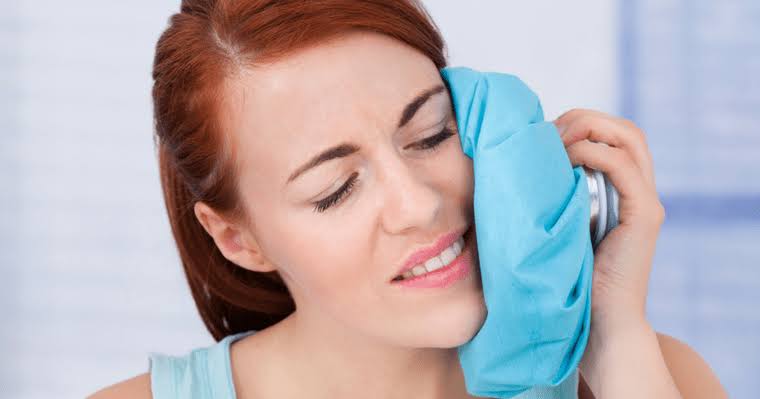 Applying a wrapped cold compress to your cheek in a structured 15-minute rotation during the first 48 hours is highly effective at reducing swelling and numbing nearby nerve endings., AI generated