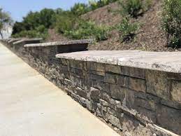 Beginning at one end of the wall, set the first block into the base layer. Walls Built On A Sloping Grade Require A Stepped Up Base To Remain Stable And Level Without Burying Ext Retaining Wall Steps How To Build Steps Retaining Wall