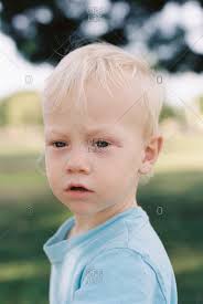 I know, i was young, bla bla bla. Portrait Of A Little Boy With Blonde Hair And Blue Eyes Outside Stock Photo Offset