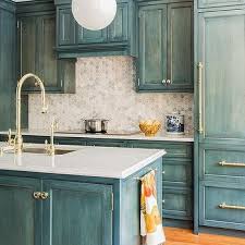Chic french country style kitchen cabinets of wooden materials in white but an island in blues. Blue Country Kitchen Design Ideas