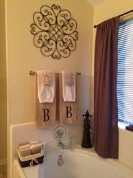 Extra linens fill the top shelf, while daily items sit at a more accessible height. Pin By Home Decoration On My Diy Projects Bathroom Towel Decor Tuscan Bathroom Decor Master Bathroom Decor