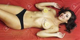 Sexy Naked Woman Covering Her Breasts With Lemons And The Phrase Nothing  Is Impossible In French Written On Left Chest On Red Sheets Stock Photo,  Picture and Royalty Free Image. Image 22015932.