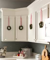 All the decorating loop holes for your christmas budgeting needs. Picture Of Simple Garland Above Kitchen Cabinet For Christmas Event