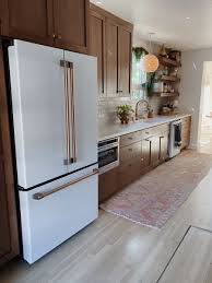 Chose either strictly dark or light cabinets and avoid anything in between. Arrowsandbow White And Wood Kitchen Home Kitchens Wood Kitchen Cabinets Brown Kitchen Cabinets