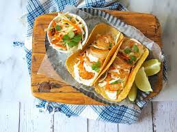 In a large bowl, whisk together lime juice, cilantro, garlic, cumin, olive oil, lime zest and season with salt. Baja Shrimp Taco Recipe With Chipotle Lime Crema