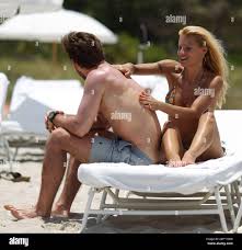 Swiss TV host and actress Michelle Hunziker spends the day in Miami Beach  with boyfriend Tomaso Trussardi. 35 year old Hunziker wore a multi-color  string bikini that showed off her amazing toned