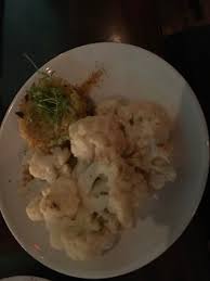 Two small slider sized cakes on a brioche roll, with a tangy remoulade and lettuce, and a side of potato chips. Cauliflower Steak Picture Of Charlie Was A Sinner Philadelphia Tripadvisor