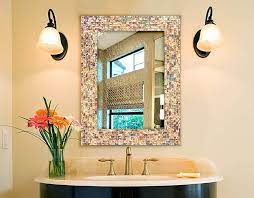 In this bathroom designed by arent & pyke, the simple bronze frame of the mirror highlights the other shimmery details throughout, and pops against the dark gray grooved drawers and black sconces. 32 Stylish Bathroom Mirror Ideas 2021 Updates