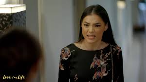 She balanced the somber color palette of her top and baggy trousers with a beige trench. Rhian Ramos