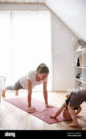 Hes trying to imitate mom. a young woman and her son doing yoga together at  home Stock Photo - Alamy