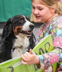Kids read to therapy dogs