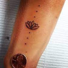 Iny Lotus And A Few Dots Other Lotus And 3 Dots Above For Three Of Us Small Tattoo Ideas Tattoos Water Lily Tattoos Body Art Tattoos