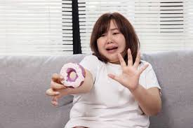Chubby Asian Woman Try To Stop Herself From Eatting Doughnut Stock Photo,  Picture And Royalty Free Image. Image 186432160.