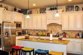 Potted plants arranged on a. How To Decorate The Top Of Kitchen Cabinets Home Design Lover