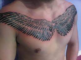 The tattoo follows the lines of the wearer's pecs and display a talent for shading. 70 Stylish Wings Tattoo For Chest