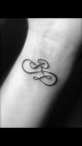 'rose' tattoo on his right cheek. Rod And Lisa Tattoo Kids Initial Tattoos Monogram Tattoo Tattoo Lettering