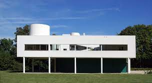 This modern villa is built with the great combination of textures provides by the smoothness of the wood and glass and the roughness of the stone bricks used for the walls and outdoor flooring. Archeyes Villa Savoye Rear Facade Completed In 1928 By Le
