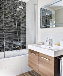 Ambient lighting radiates a soft glow, wood finishes emit warmth, and the green floral wallpaper brings the entire room to life; En Suite Bathroom Ideas En Suite Bathrooms For Small Spaces Loft Rooms