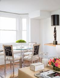 Adding a fun chandelier, rug, and circle table complete the look. Crop Breakfast Nook Black And White Chairs House Home