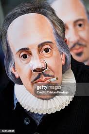 Crowds of people wear William Shakespeare masks during the Shakespere...  News Photo