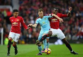 Ashley Barnes Of Burnley Is Tackled By Paul Pogba Of Manchester United And Is Put Under Pressure From Jesse Lingard Of Man Manchester United Burnley Manchester