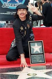 8 17 In 1998 Carlos Santana Is Awarded A Star On The Hollywood Walk Of Fame International Music Music Star Santana