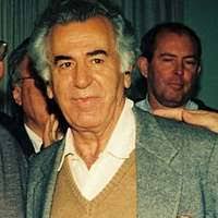 Barber Louis McDowell poses for photos in his barber shop.